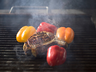 Image showing steak with vegetables on a barbecue