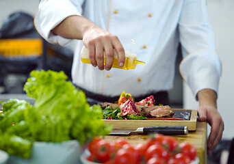 Image showing Chef finishing steak meat plate