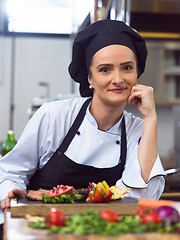 Image showing female Chef preparing beef steak