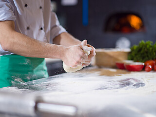 Image showing chef hands preparing dough for pizza