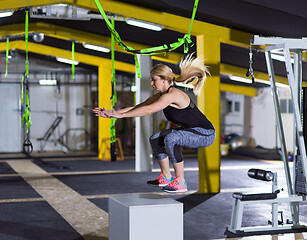 Image showing woman working out  jumping on fit box