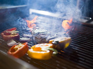 Image showing steak with vegetables on a barbecue