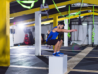Image showing man working out jumping on fit box