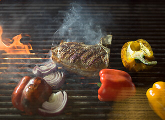 Image showing steak with vegetables on a barbecue