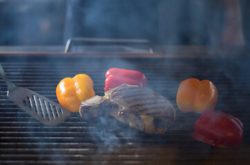 Image showing steak with vegetables on a barbecue