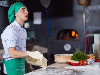 Image showing chef throwing up pizza dough