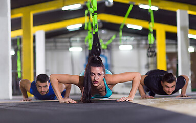 Image showing young healthy people doing pushups