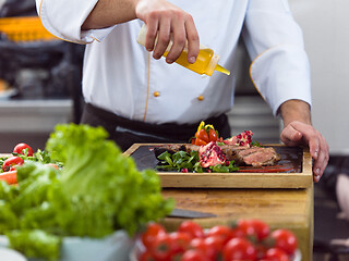 Image showing Chef finishing steak meat plate