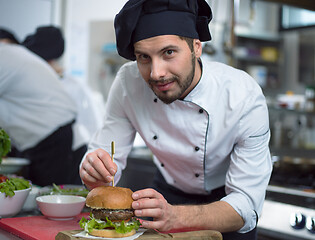 Image showing chef finishing burger