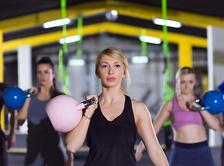 Image showing athletes doing exercises with kettlebells