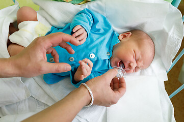 Image showing crying newborn baby infant in the hospital