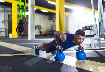 Image showing Young strong man doing pushups