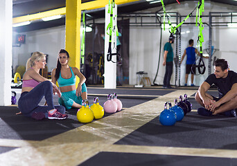 Image showing young athletes sitting on the floor and relaxing