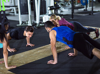 Image showing young healthy people doing pushups