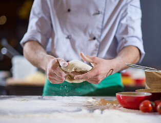 Image showing chef hands preparing dough for pizza