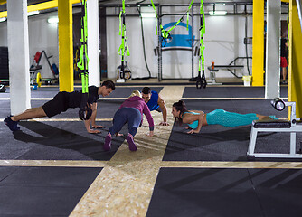 Image showing young healthy people doing pushups