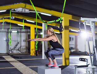 Image showing woman working out  jumping on fit box
