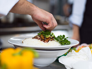 Image showing Chef hands serving spaghetti