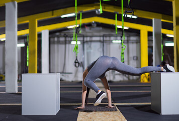 Image showing woman working out gymnastic exercise on fit boxes