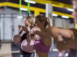 Image showing athletes doing exercises with kettlebells