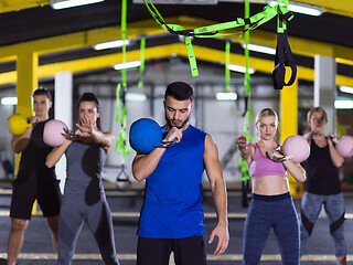 Image showing athletes doing exercises with kettlebells