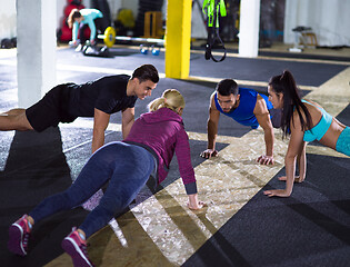 Image showing young healthy people doing pushups