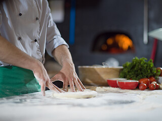 Image showing chef preparing dough for pizza