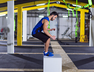 Image showing man working out jumping on fit box