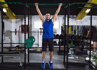 Image showing man doing pull ups on the horizontal bar