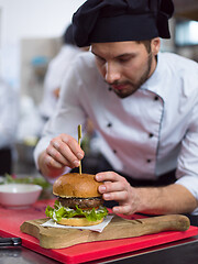 Image showing chef finishing burger