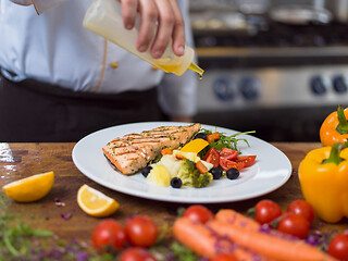 Image showing Chef finishing steak meat plate