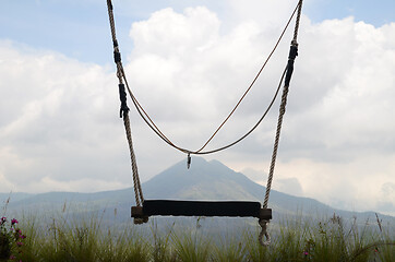 Image showing Wooden swing on the rope with view of Batur volcano