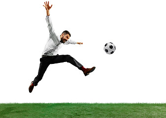 Image showing Full length shot of a young businessman playing football isolated on white background