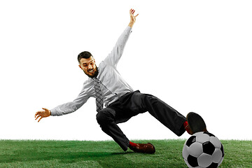 Image showing Full length shot of a young businessman playing football isolated on white background