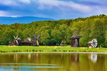 Image showing Windmills on the Bank of Lake