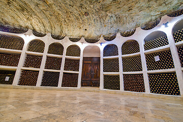 Image showing Old wine bottles and old doors in winery