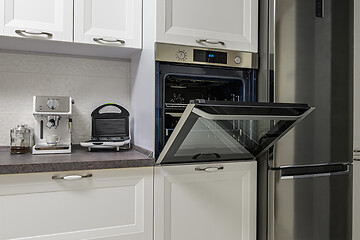 Image showing Electric appliances in minimalistic white kitchen interior