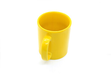 Image showing Bright yellow ceramic cup on white background