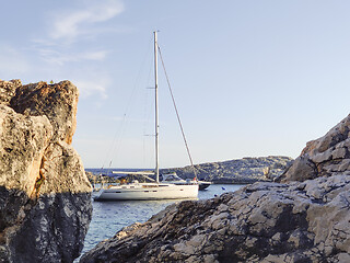 Image showing Sailboat mooring in a small cove of beach Velo Zarace on Hvar island, Croatia in sunset