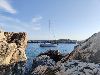 Image showing Sailboat mooring in a small cove of beach Velo Zarace on Hvar island, Croatia in sunset