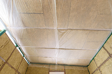 Image showing Insulated ceiling of a country house, insulation is closed with a vapor barrier film