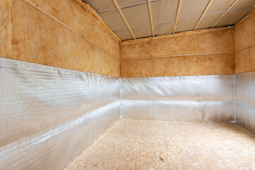 Image showing Combination of insulation during the construction of a house, a heat-insulating layer of reflective foamed polyethylene laminated with lavsan when insulating a house