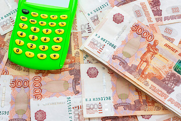 Image showing A pile of five thousandth Russian bills and a calculator