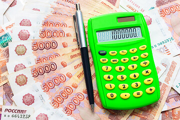 Image showing A calculator with the number one million and a ballpoint pen lie against the background of Russian five-thousandth bills