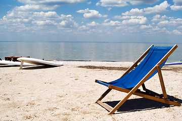 Image showing Chair on a beach against a gulf and clouds