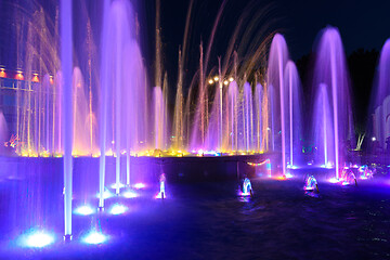 Image showing Jets of a night multi-colored illuminated fountain close-up