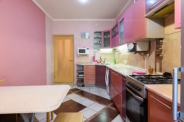 Image showing Fragment of the interior of a small furnished kitchen, view from the window to the front door