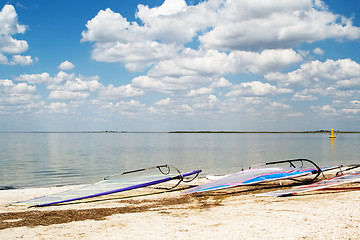 Image showing Surfboards on a beach a sea bay on background of the blue sky an