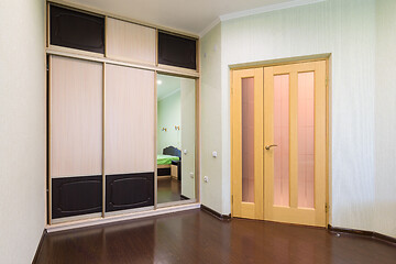 Image showing Fragment of the bedroom interior, view of the wardrobe and the interior door