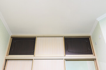 Image showing The mezzanine of the wardrobe close-up in the interior of the bedroom